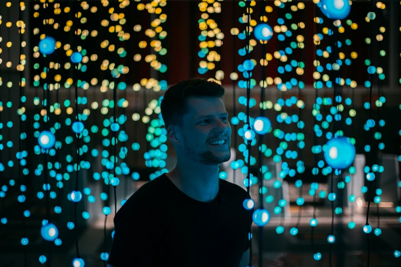 a man standing in front of a lot of lights