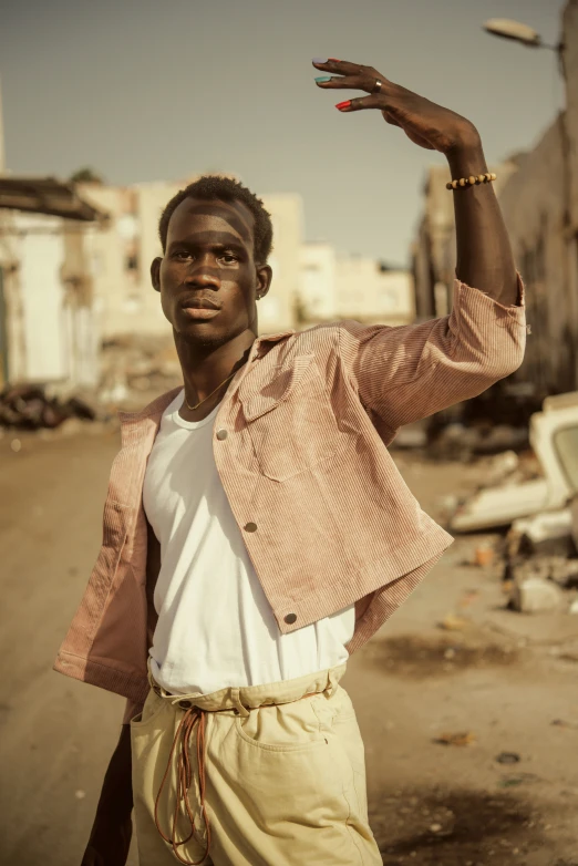 a man in brown shorts holding his hand up