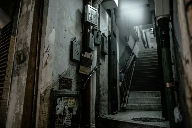 a stairway with a dark colored ceiling and tiled walls