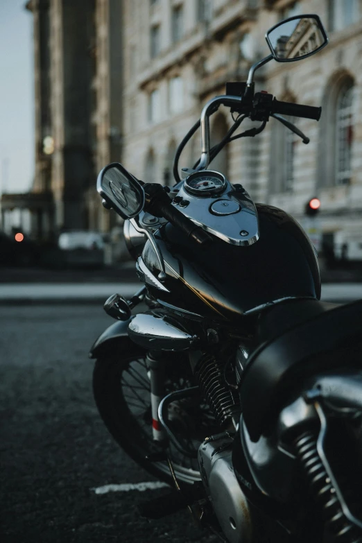 the side of a parked motorcycle on a city street