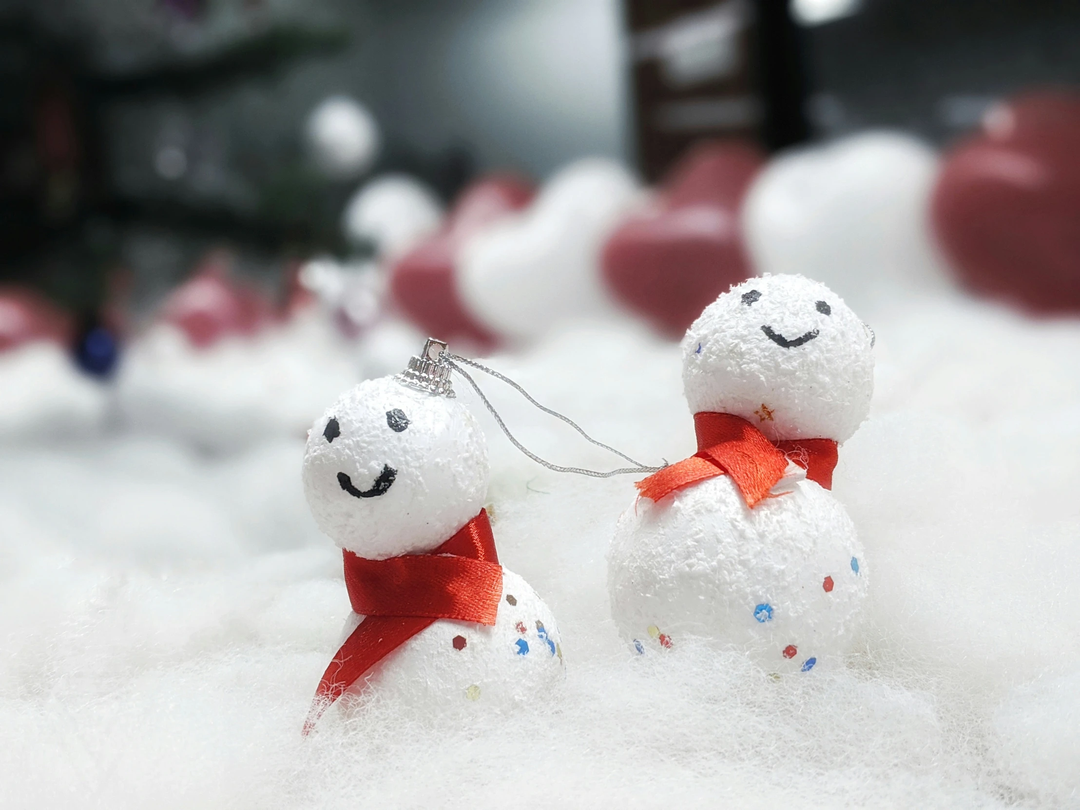 two snowman figures sitting in the snow