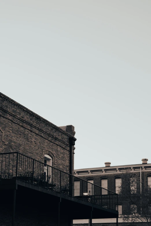 a dark building is seen in the background with a balcony and a balcony top