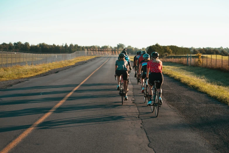 group of people on bicycles traveling down the road