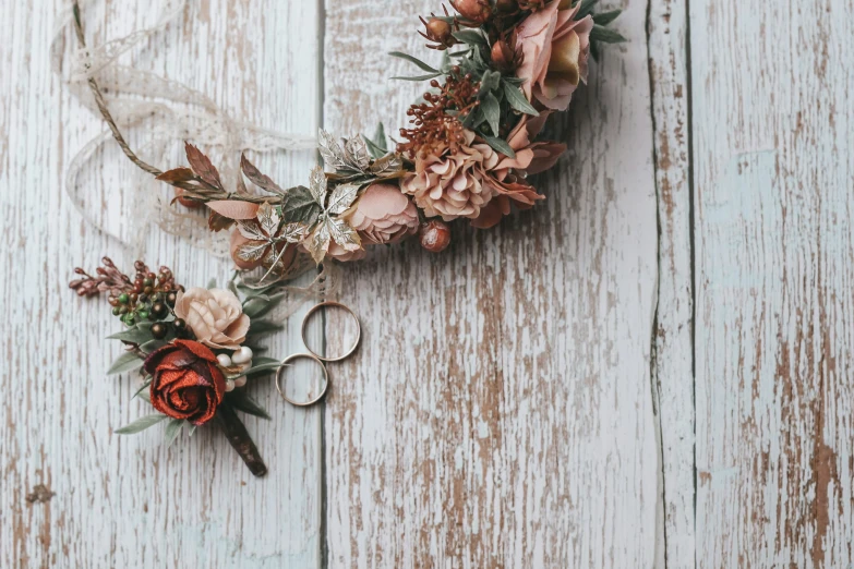 flower arrangement with pair of scissors on wooden background