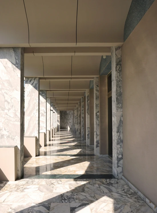 the inside of an empty building is lined with marble pillars