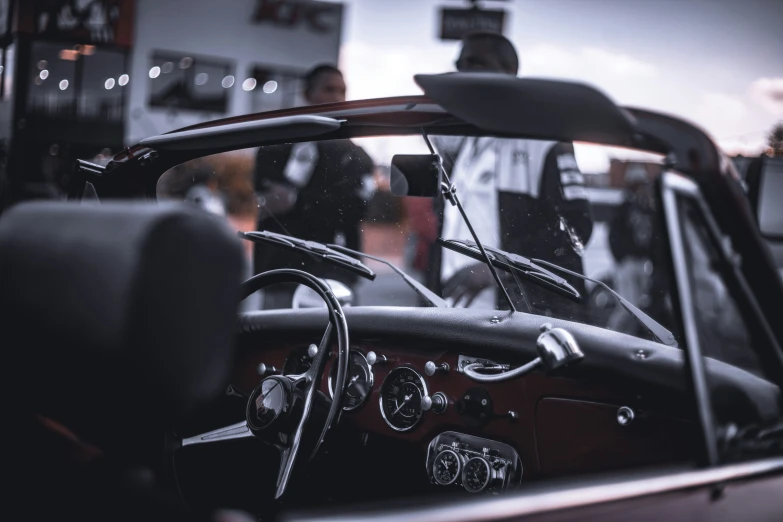 an old model car sits parked inside a building