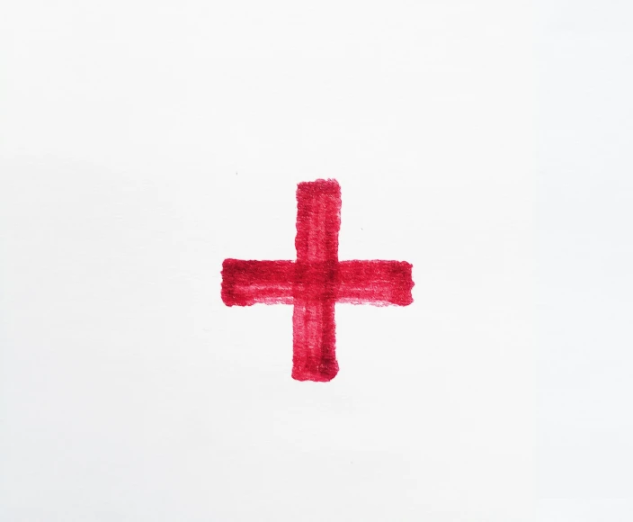the cross is drawn in a water color on a paper