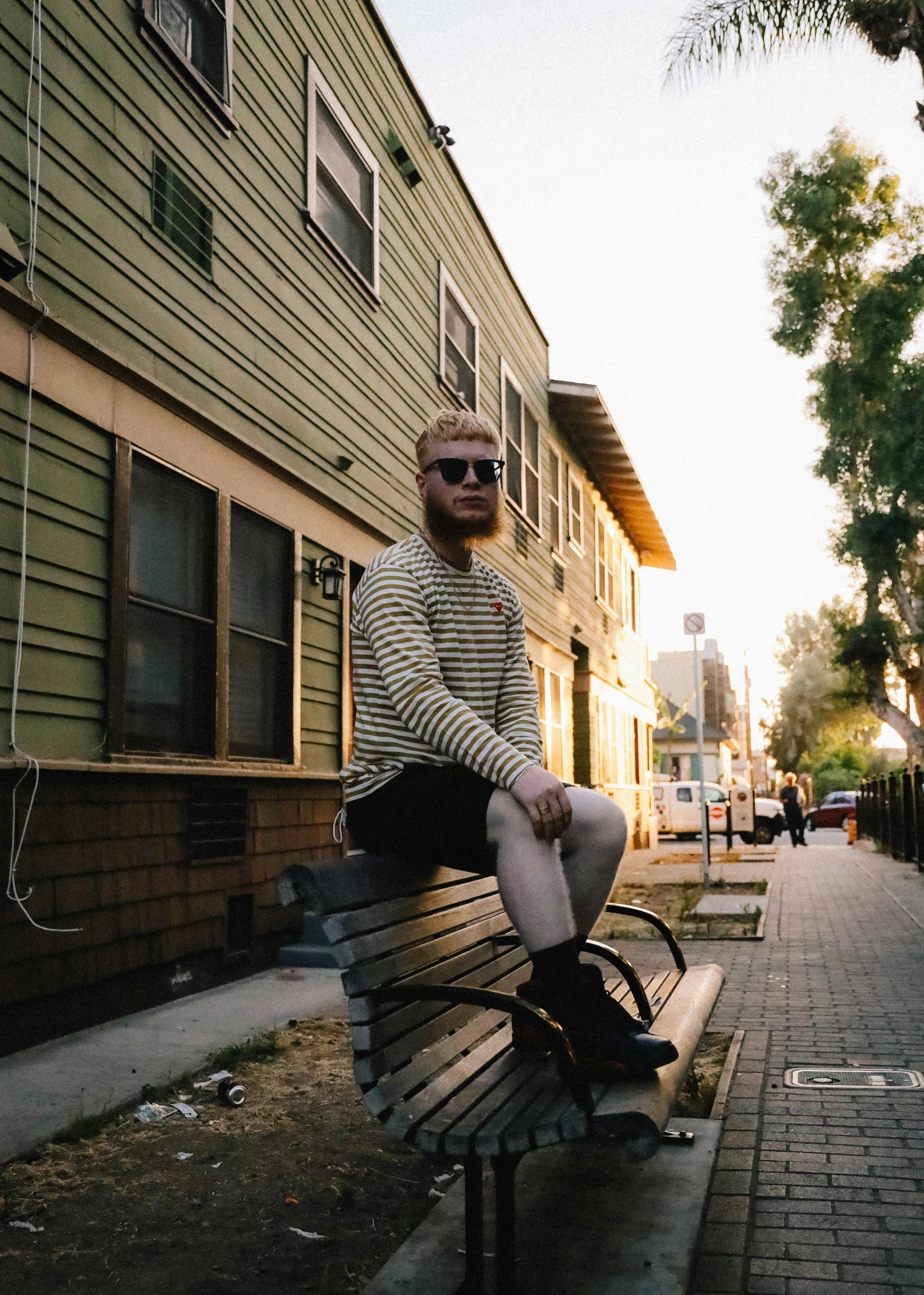 a man is sitting on a bench outside