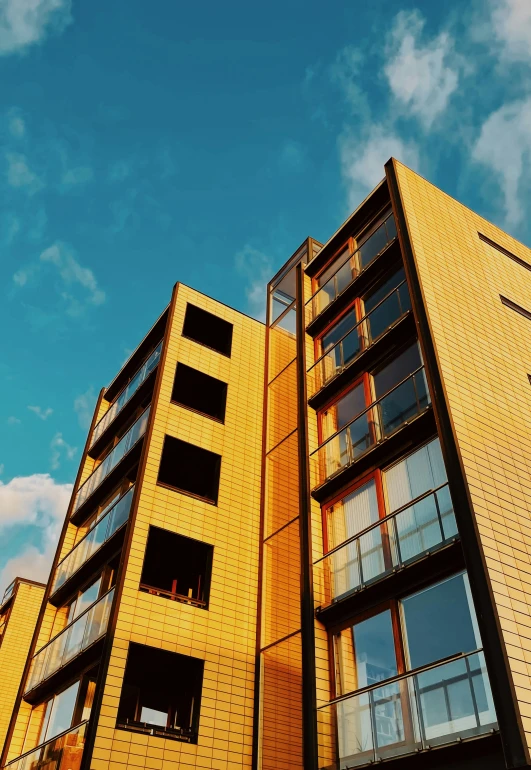 the front of a yellow building under a cloudy sky