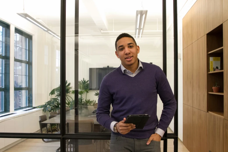 a man is holding an electronic tablet