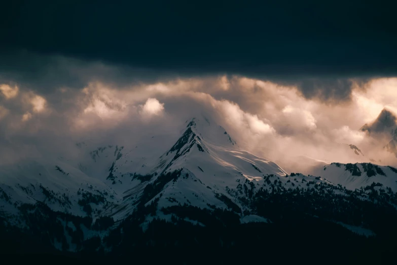 a cloudy view of a large mountain range