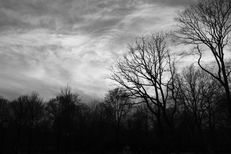 the sky is filled with dark clouds in black and white