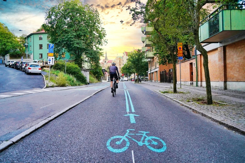 bicycle path painted with blue arrows on roadway