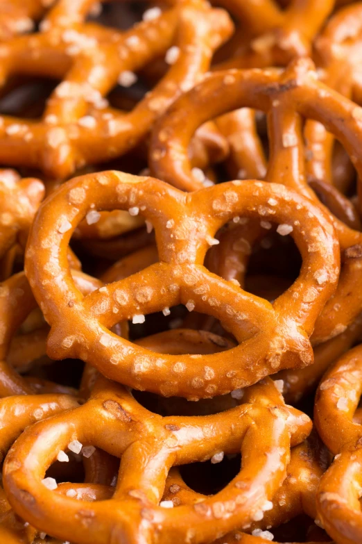 many caramel pretzels with white sesame seeds on top