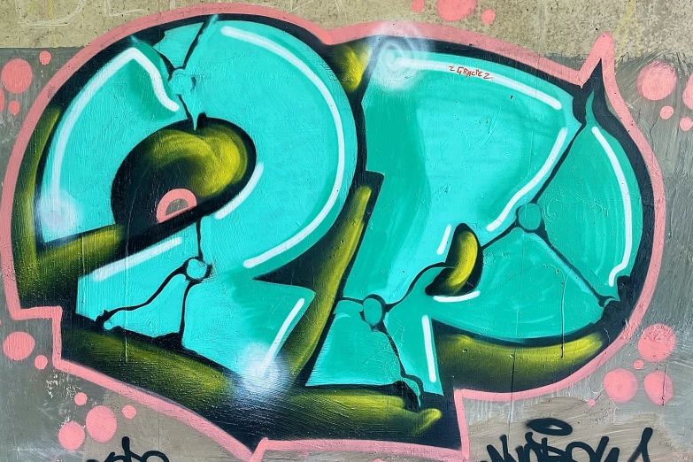 graffiti on the side of a building has green letters