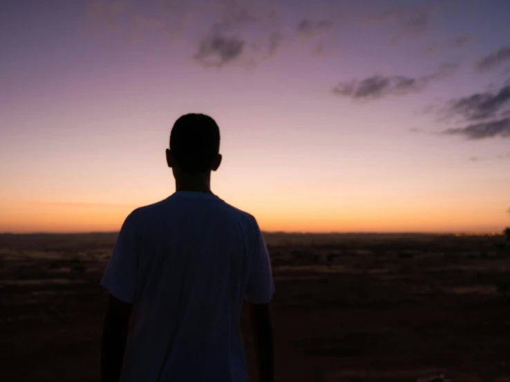 a person in the evening watching a sunset