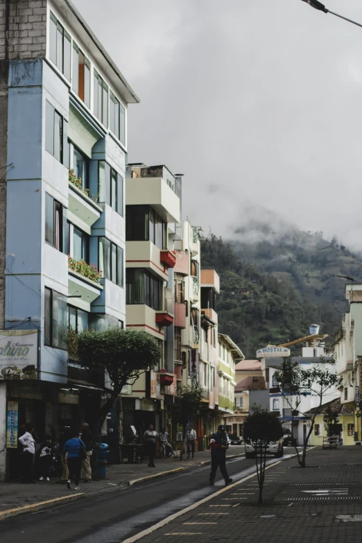 a city street with some buildings and people walking in it