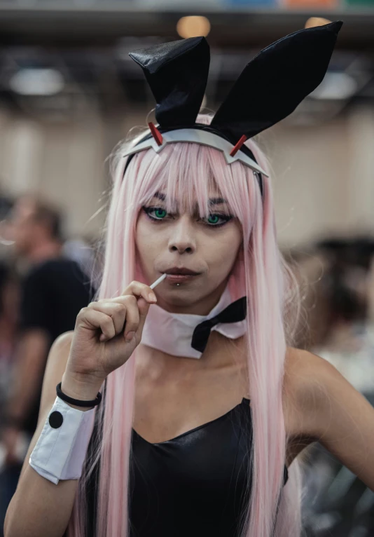 a girl in bunny ears smoking a cigarette