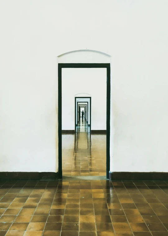 a long hallway with black and white columns in between two walls