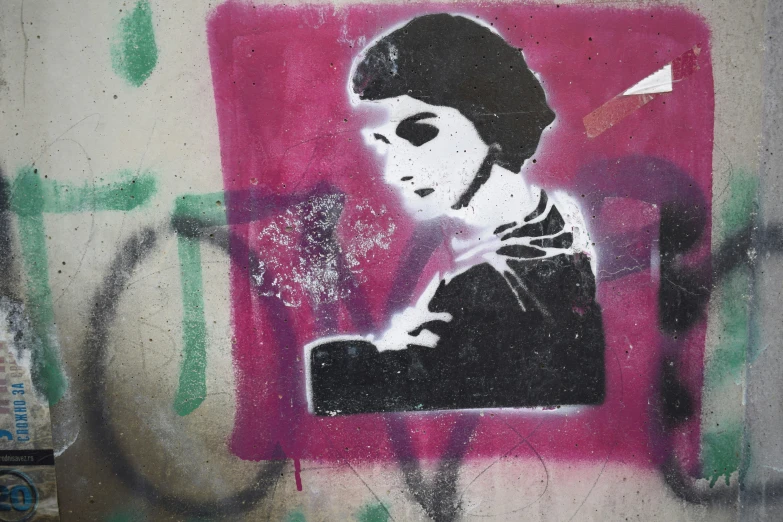 a graffit of a girl using a cell phone