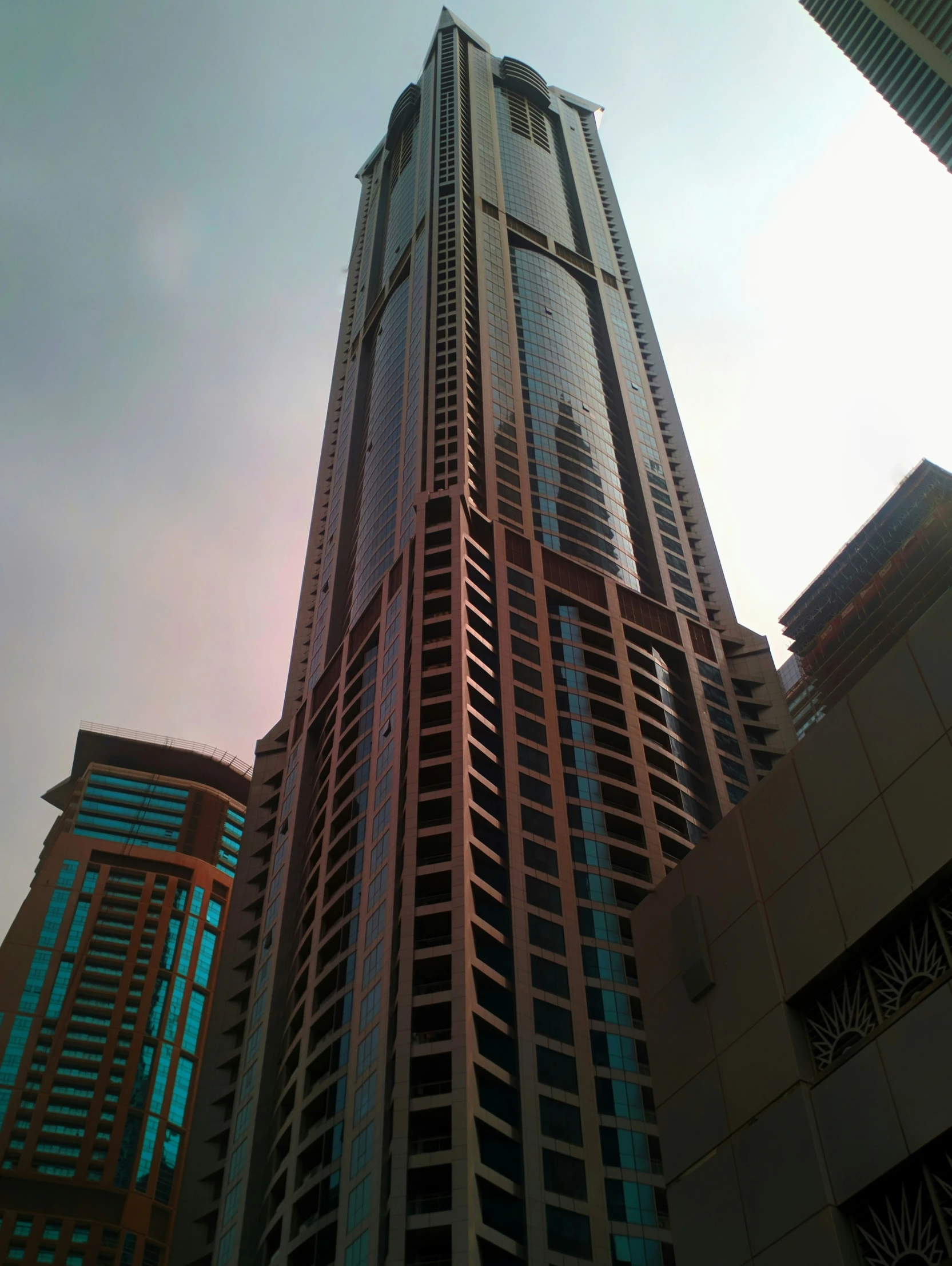 an upward view of two tall skyscrs near each other