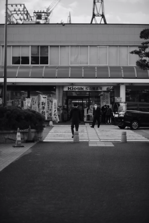 people walking out onto a city sidewalk