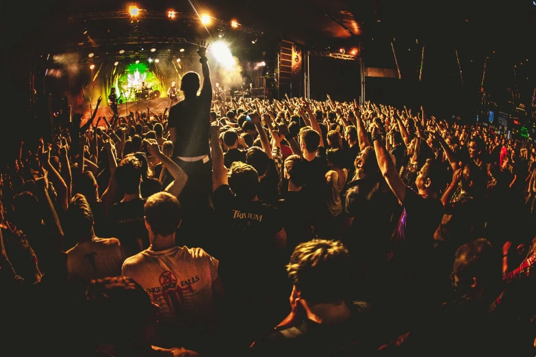 a large crowd of people on stage at a concert