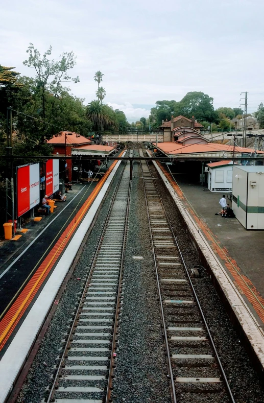 a railroad yard with several train tracks and buildings