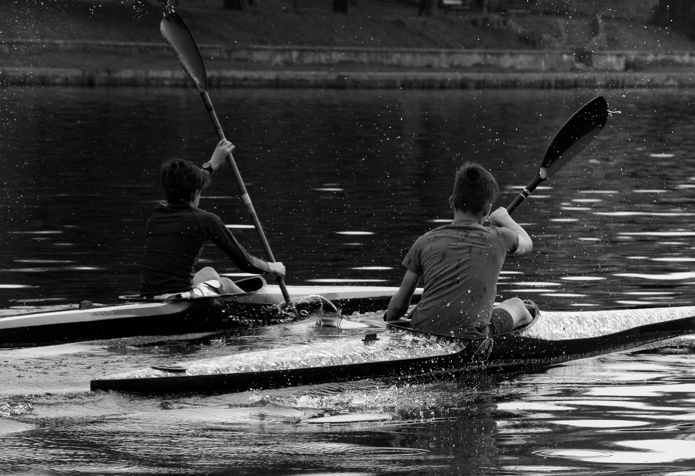 two people are on their canoes in the water