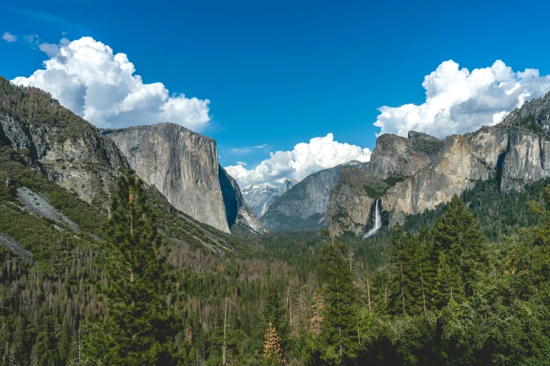 the view of a valley and mountains from the trail