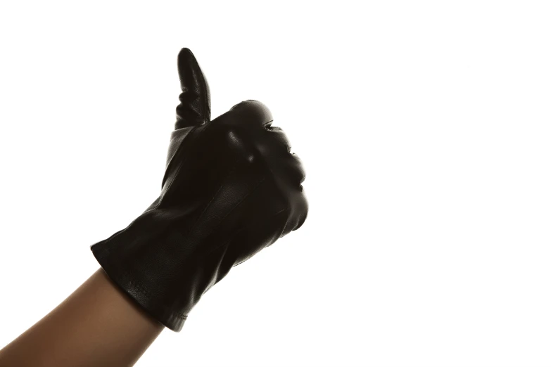 a woman's hand in a leather glove making the thumbs up