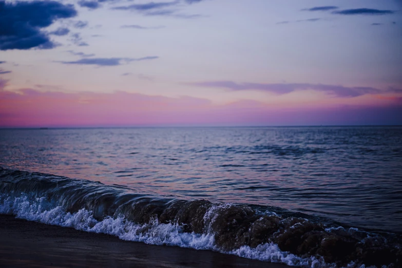 a picture of some water and a pink sky