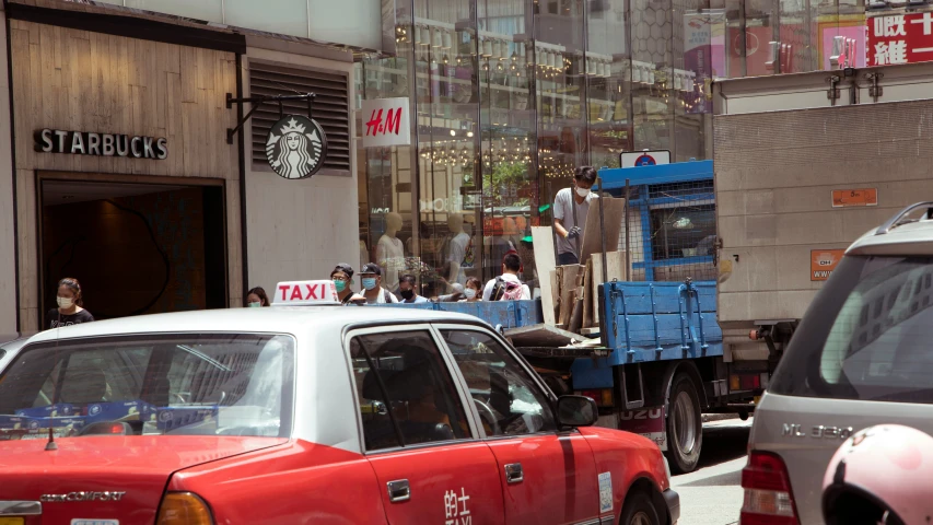 the car is driving on the road near the large truck