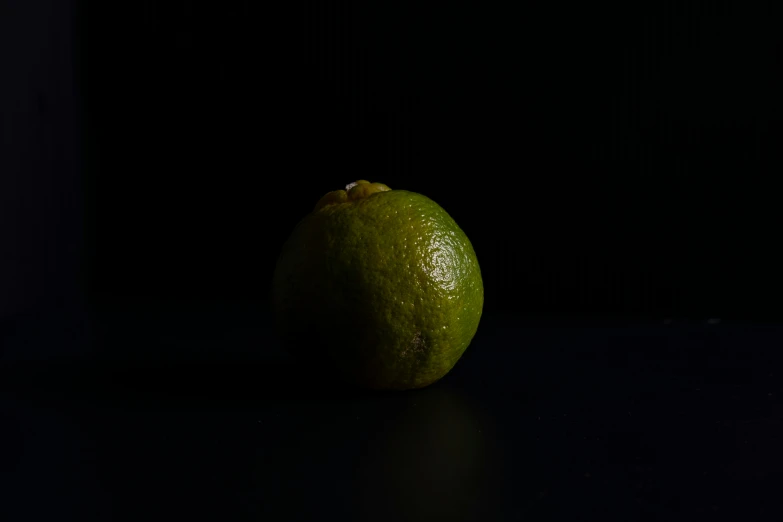 a green gfruit with its head slightly lit