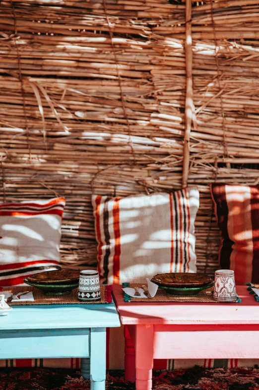 some cushions and a table with plates on it