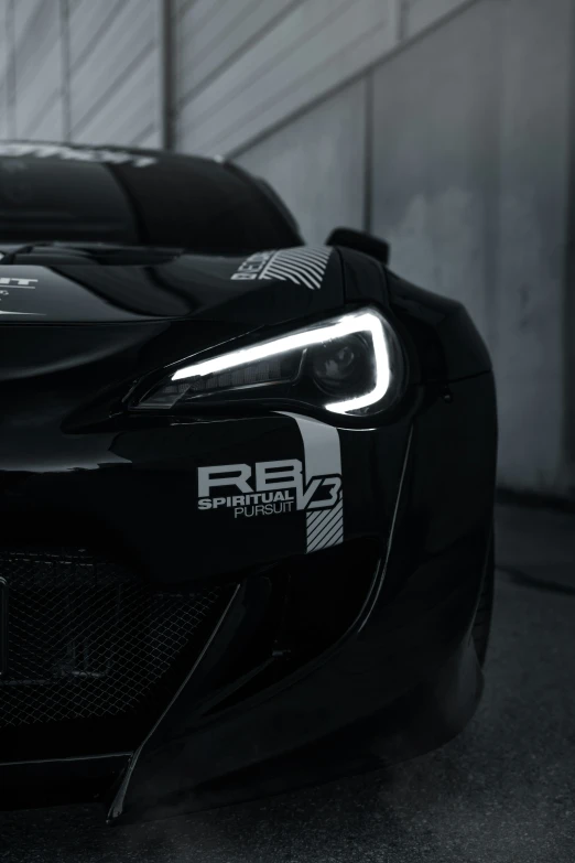 the front of a black sports car in a garage