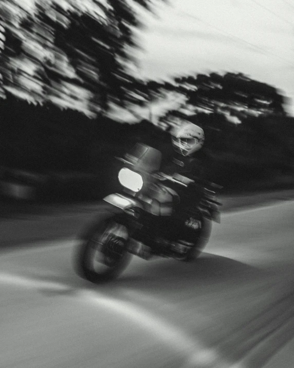 a person on a motorcycle in the dark on a street
