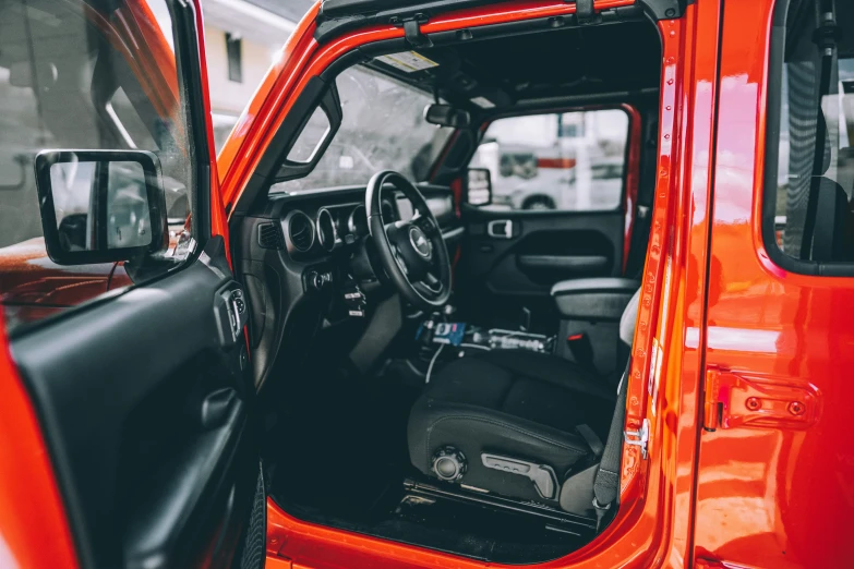 the interior of a jeep truck with the doors open