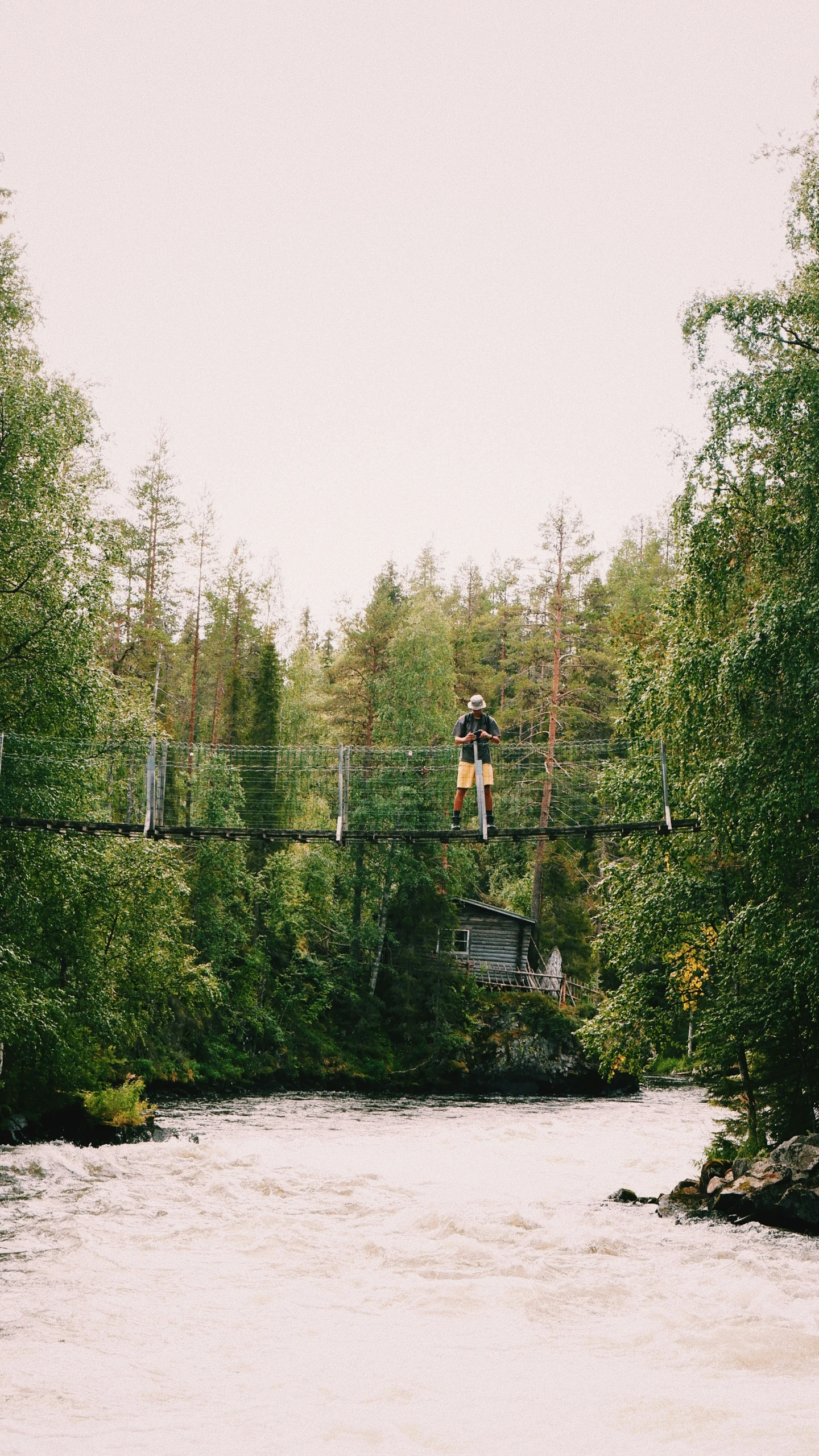 an individual is jumping high from a bridge