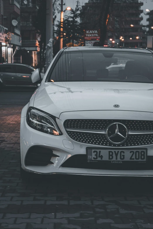 the front view of a car parked on a brick road