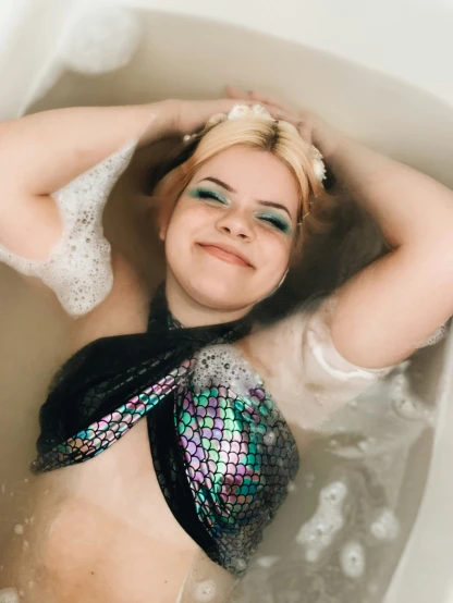the young lady is relaxing in her bathtub
