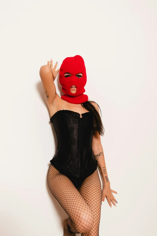 a woman wearing fishnet stockings and a red mask