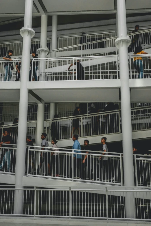 people walking down the balcony between two balconies