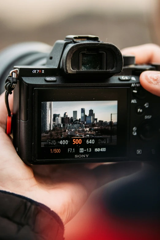 a man holding up a black camera in front of his face