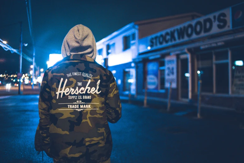 man walking alone on a street during the night