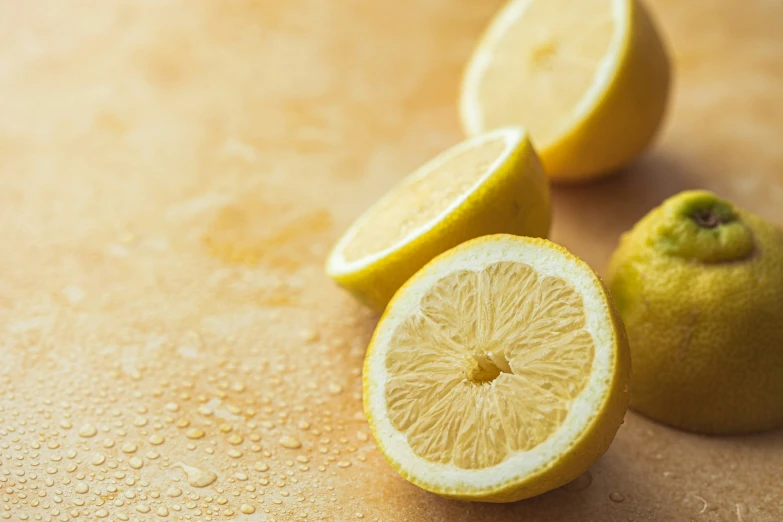 a whole and cut lemon on a surface