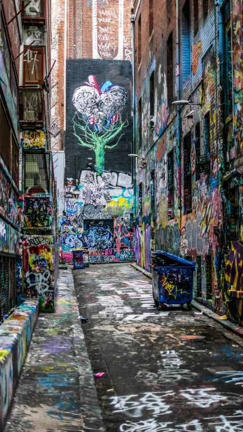 there is graffiti written on the walls in an alley