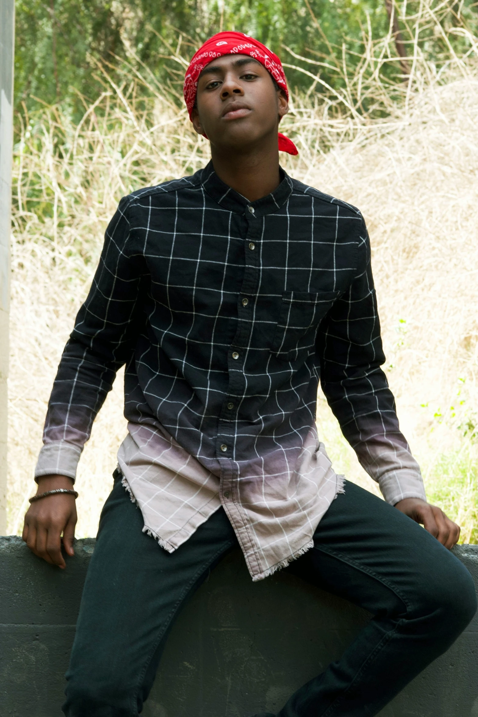 a young man posing with his legs crossed