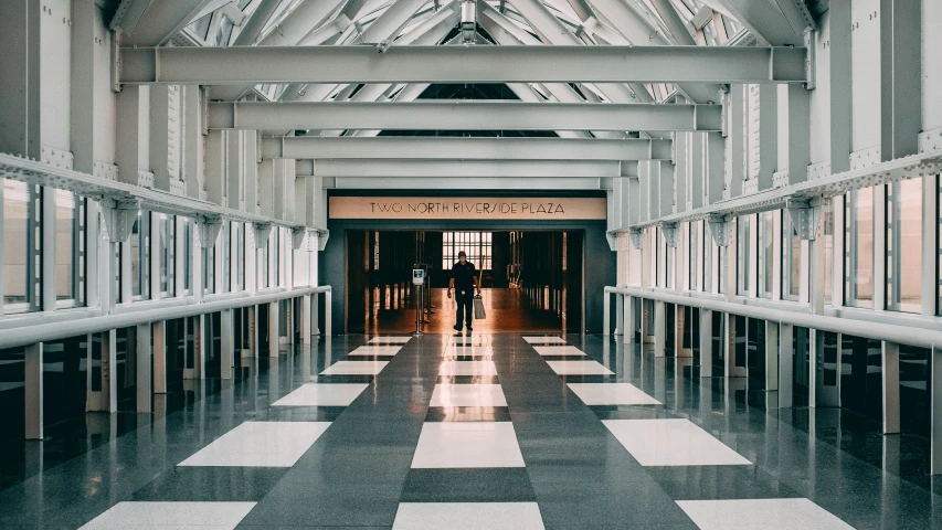 the interior of an old building with people walking in it