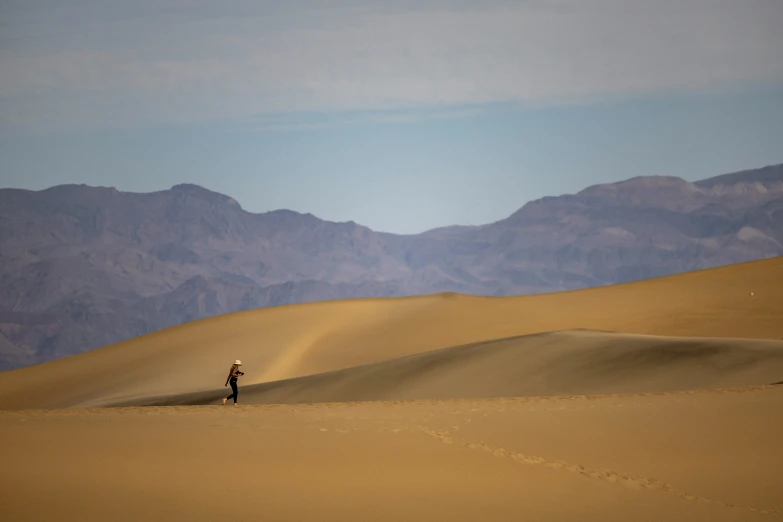 a lone person is walking alone across a vast landscape